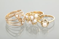 Lot 1184 - THREE NINE CARAT GOLD PEARL SET DRESS RINGS...