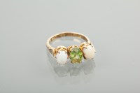 Lot 1207 - PERIDOT AND OPAL RING the central oval peridot...