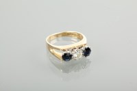 Lot 1224 - DIAMOND AND SAPPHIRE THREE STONE RING the...