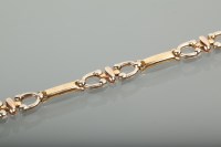 Lot 1265 - EIGHTEEN CARAT GOLD BRACELET with bar and bit...