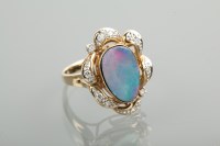 Lot 1268 - OPAL AND DIAMOND DRESS RING the central opal...