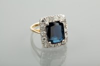 Lot 1269 - SAPPHIRE AND DIAMOND CLUSTER RING the central...