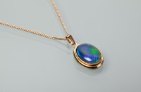 Lot 1337 - OPAL PENDANT the oval stone with blue tones...