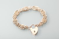 Lot 1346 - NINE CARAT ROSE GOLD BRACELET with a padlock...