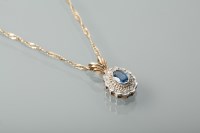 Lot 1347 - SAPPHIRE AND DIAMOND PENDANT the oval sapphire...