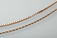 Lot 1348 - TWO NINE CARAT GOLD CHAINS one with box links,...