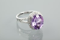 Lot 1361 - AMETHYST AND DIAMOND CLUSTER RING the oval cut...