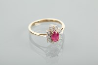 Lot 1390 - RUBY AND DIAMOND CLUSTER RING the central oval...