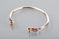 Lot 1390A - UNUSUAL RUBY SET TORC BANGLE each terminal set...