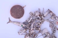 Lot 1862 - STERLING SILVER CHARM BRACELET with charms...