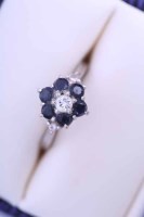 Lot 1879 - SAPPHIRE AND DIAMOND CLUSTER RING with a...