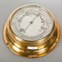 Lot 272 - LACQUERED BRASS BULKHEAD BAROMETER with enamel...