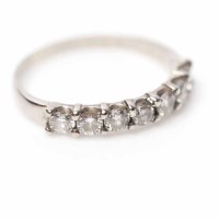 Lot 1925A - DIAMOND HALF ETERNITY RING set with a row of...