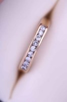 Lot 1928 - DIAMOND HALF ETERNITY RING channel set with a...