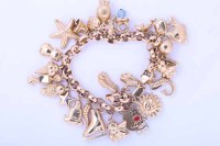 Lot 1931 - NINE CARAT GOLD CHARM BRACELET with charms...