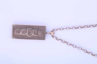 Lot 1943 - NINE CARAT GOLD INGOT PENDANT on a nine carat...