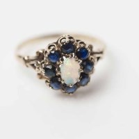 Lot 1948A - OPAL AND SAPPHIRE CLUSTER RING with a central...