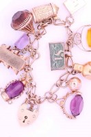 Lot 1950 - NINE CARAT GOLD CHARM BRACELET with charms...