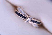 Lot 1951 - DIAMOND AND SAPPHIRE CROSSOVER RING channel...