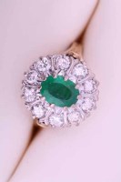 Lot 1958 - EMERALD AND DIAMOND CLUSTER RING the central...