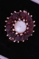 Lot 1972 - GARNET AND PEARL DRESS RING the central pearl...