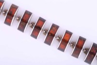 Lot 2005A - SILVER AND AMBER BRACELET set with curved...