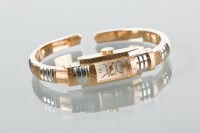 Lot 1030 - LADY'S BAUME BANGLE WATCH plated in yellow and...