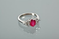 Lot 1106 - RUBY AND DIAMOND DRESS RING the central oval...