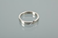 Lot 1144 - DIAMOND SET WEDDING BAND set with a single...