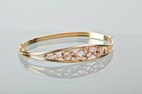 Lot 1154 - GOLD BANGLE BY CLOGAU GOLD of oval form, 67mm...