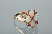 Lot 1158 - OPAL AND RUBY DRESS RING set with four oval...