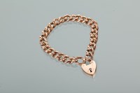 Lot 1175 - NINE CARAT GOLD CURB LINK BRACELET in rose...