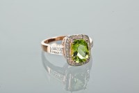 Lot 1188 - PERIDOT AND DIAMOND DRESS RING set with a...