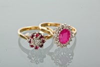 Lot 1205 - TWO RUBY AND DIAMOND CLUSTER RINGS one with an...
