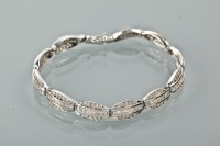 Lot 1206 - DIAMOND SET BRACELET with oval cut links set...