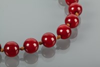 Lot 1214 - RED AMBER BEAD NECKLACE the beads of overall...