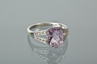 Lot 1220 - AMETHYST AND DIAMOND RING with a faceted...