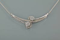 Lot 1244 - DIAMOND SET NECKLACE set with two clusters of...