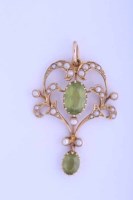 Lot 2049 - PERIDOT AND SEED PEARL PENDANT set with a...