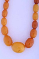 Lot 2082 - AMBER BEAD NECKLACE with graduated oval beads,...