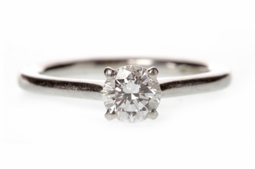 Lot 530 - PLATINUM DIAMOND SOLITAIRE RING with a four...