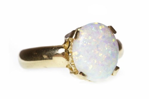 Lot 567 - CREATED OPAL DRESS RING set with a single oval...