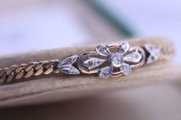 Lot 2168 - DIAMOND BRACELET set with a floral design...