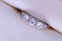 Lot 2175 - DIAMOND THREE STONE RING set with a row of...