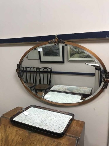 Lot 77 - OVAL OVERMANTEL MIRROR in copper frame, along...