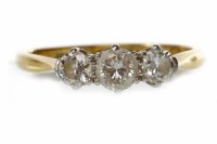 Lot 83 - DIAMOND THREE STONE RING set with a central...