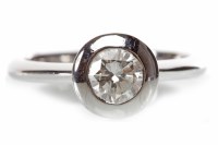 Lot 136 - DIAMOND SOLITAIRE RING with a broad collet set...