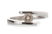 Lot 517 - DIAMOND SINGLE STONE RING with a tension set...