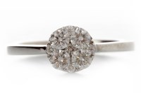 Lot 560 - DIAMOND CLUSTER RING with a round bezel set...
