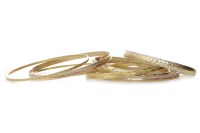 Lot 662 - SIX FOURTEEN CARAT GOLD BANGLES each with...